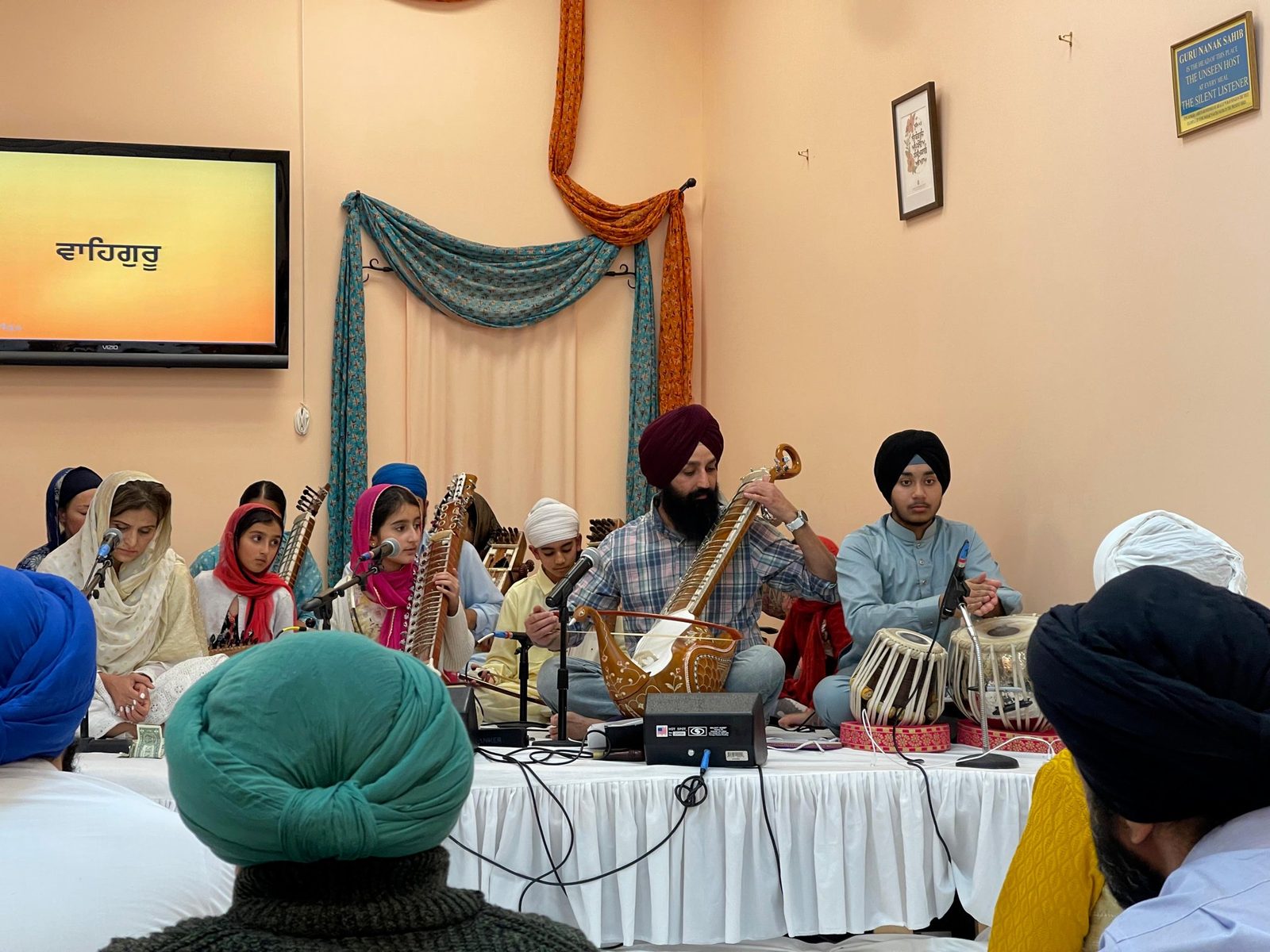 GAISS students performing kirtan together on dilruba, sarangi, and tabla